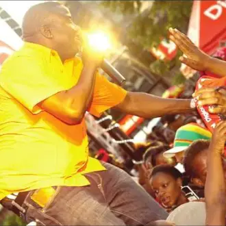 Singer performing and reaching out to the audience.