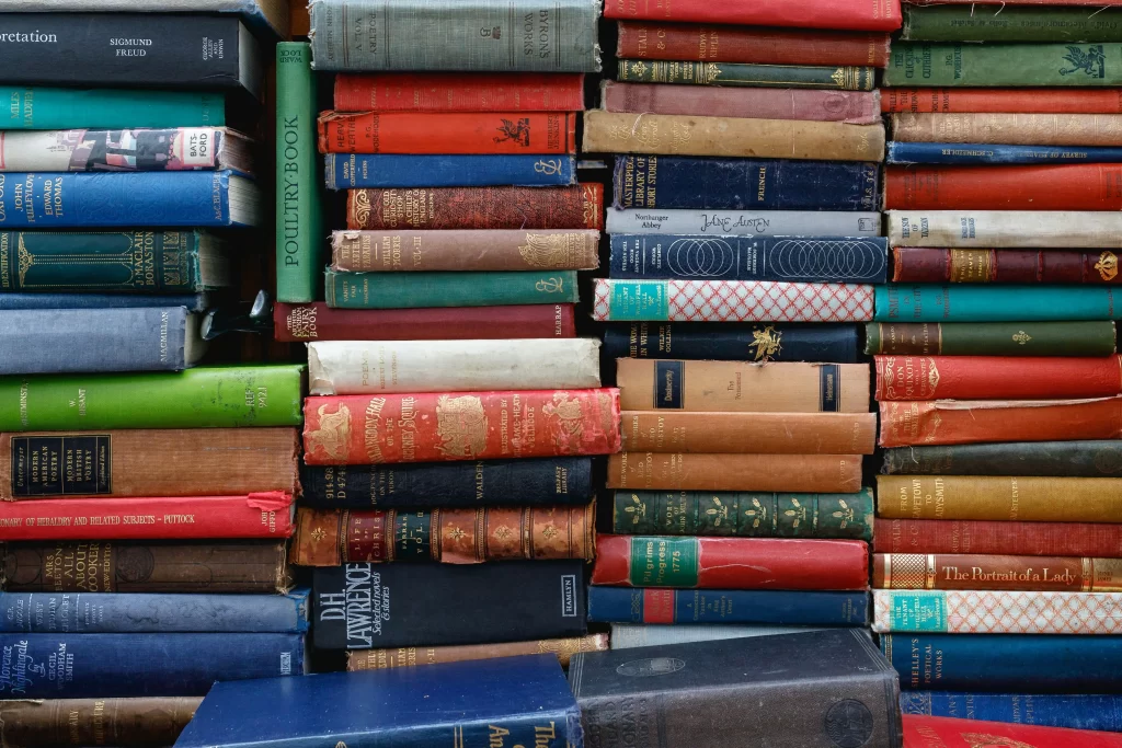 A photo of many books stacked vertically. (Photo by Ed Robertson on Unsplash.)